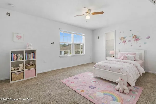 a spacious bedroom with a bed and a cabinets