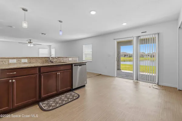a kitchen with stainless steel appliances granite countertop a sink and a stove