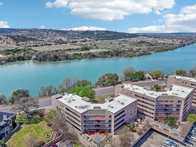 an aerial view of a house with a lake view