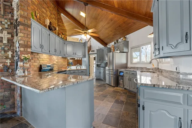 a kitchen with stainless steel appliances granite countertop a sink stove and cabinets