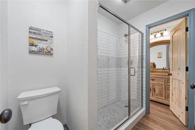 a bathroom with a toilet and a shower