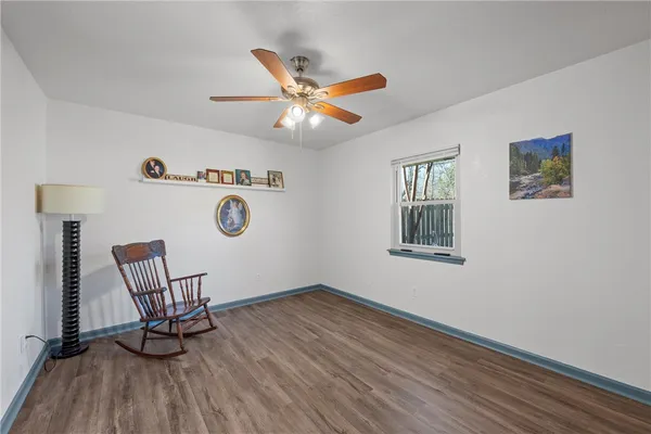 a view of workspace with wooden floor and ceiling fan