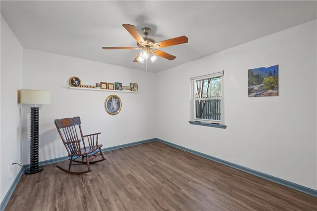 a view of workspace with wooden floor and ceiling fan