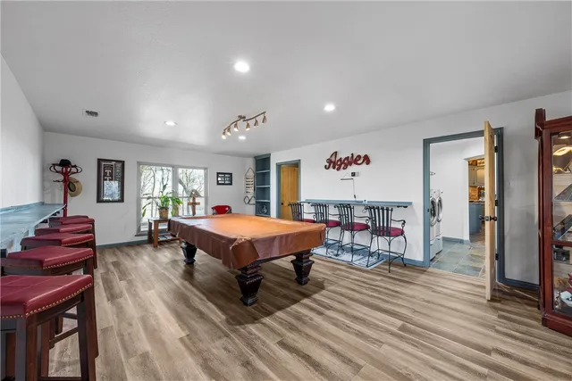 a living room with furniture a table and wooden floor