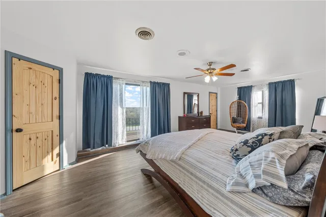 a spacious bedroom with a bed and a large window