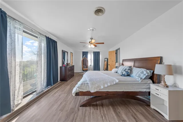 a bedroom with a large bed and a chandelier