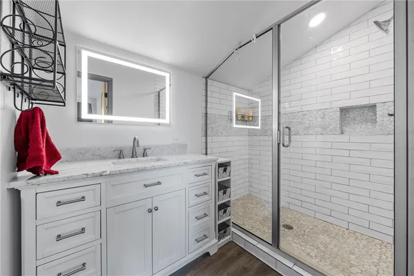 a bathroom with a granite countertop sink and a mirror