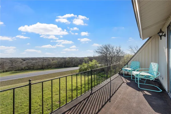 a view of a balcony with wooden floor