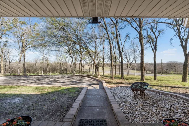 a view of yard with swimming pool and green space