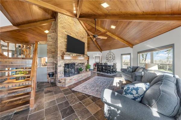 a living room with furniture a fireplace and a flat screen tv