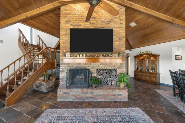 a living room with fireplace furniture and a flat screen tv