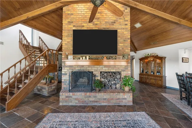 a living room with fireplace furniture and a flat screen tv