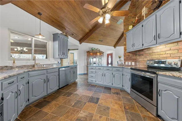 a kitchen with a sink cabinets and window