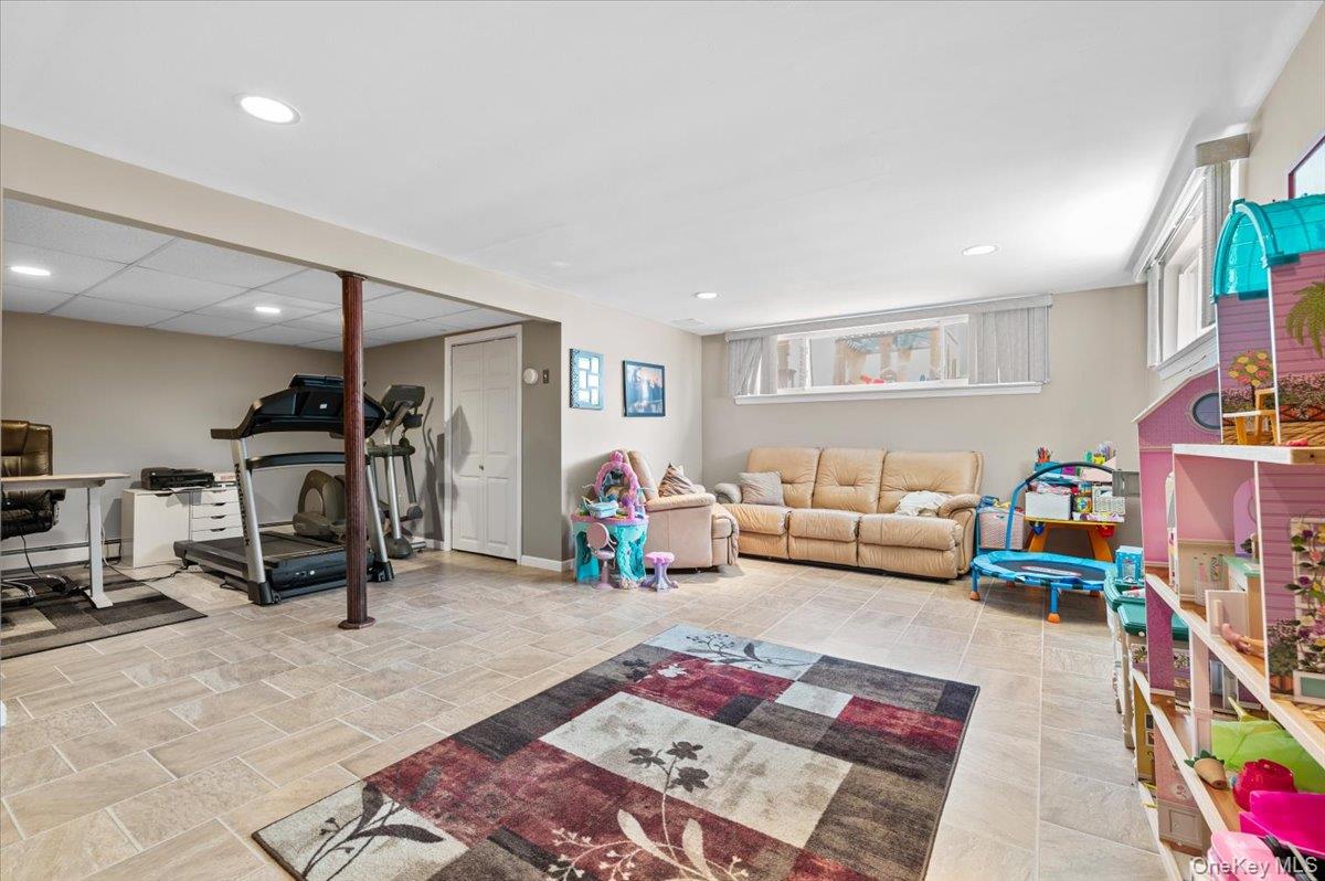 61 Winthrop Road Plainview, NY 11803 - Photo 25 of 37 a living room with lots of furniture and a couch