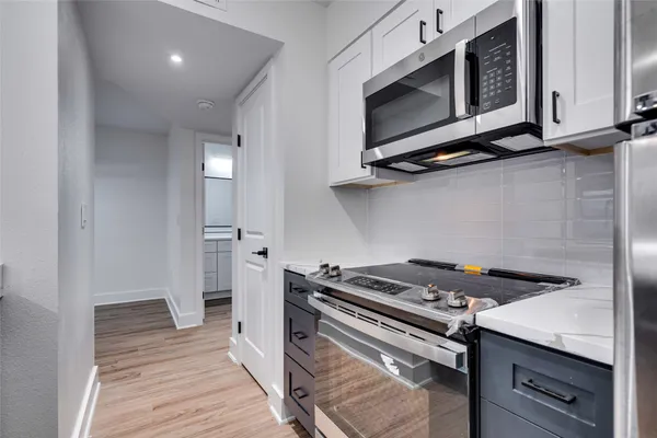 a kitchen with a stove and a microwave