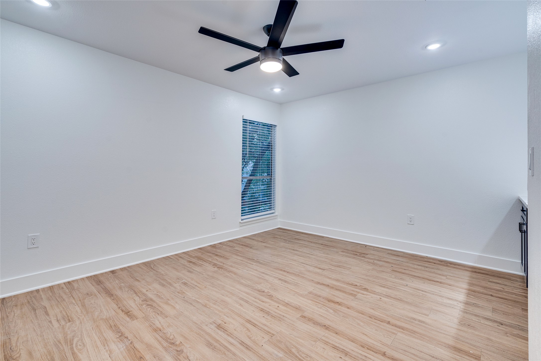 205 East 45th Street, Unit 202 Austin, TX 78701 - Photo 18 of 29 an empty room with wooden floor and a ceiling fan