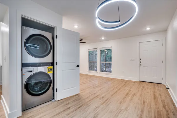 a view of a bedroom with washer and dryer