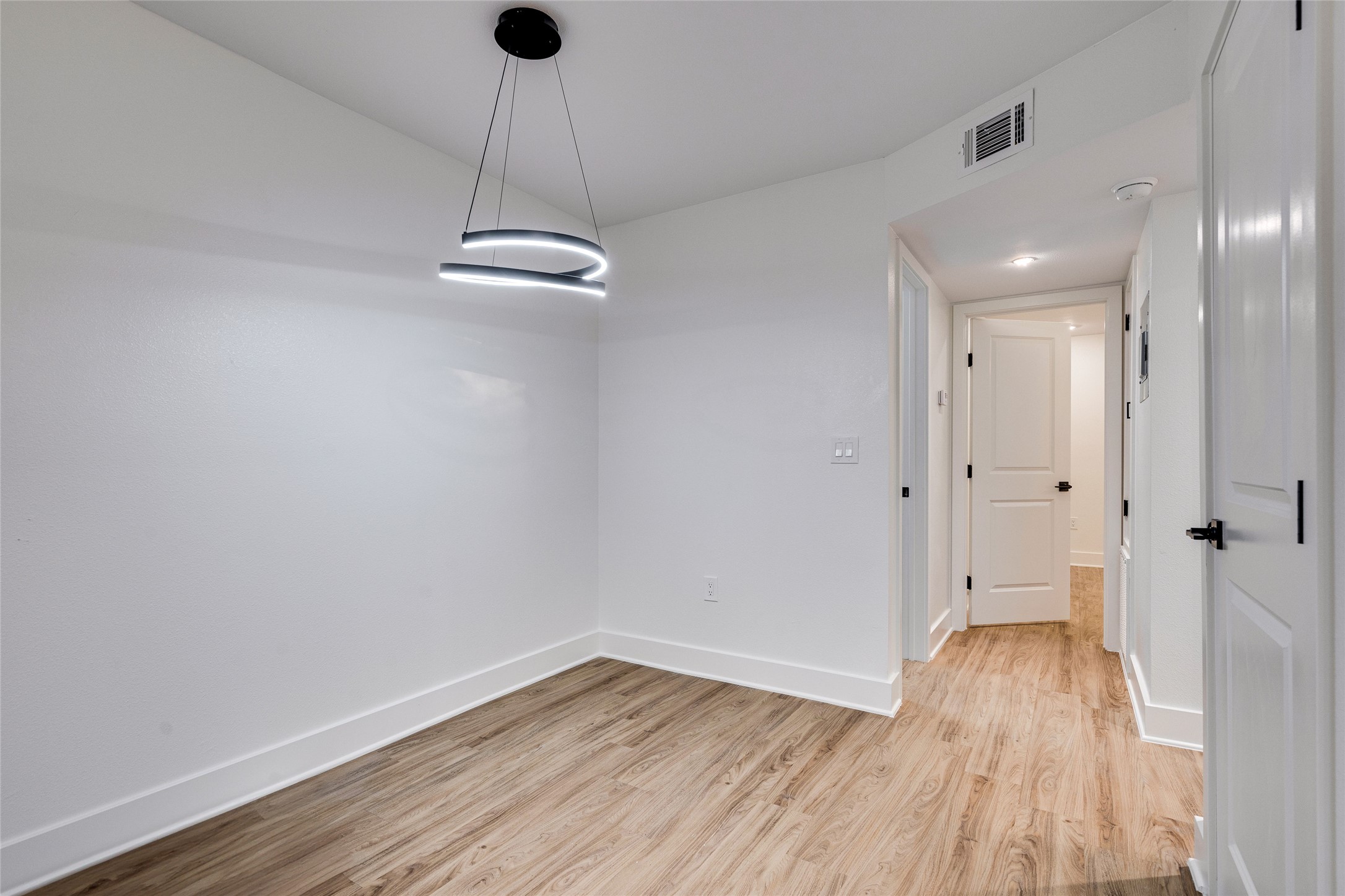 205 East 45th Street, Unit 202 Austin, TX 78701 - Photo 7 of 29 a view of a room with wooden floor and a ceiling fan