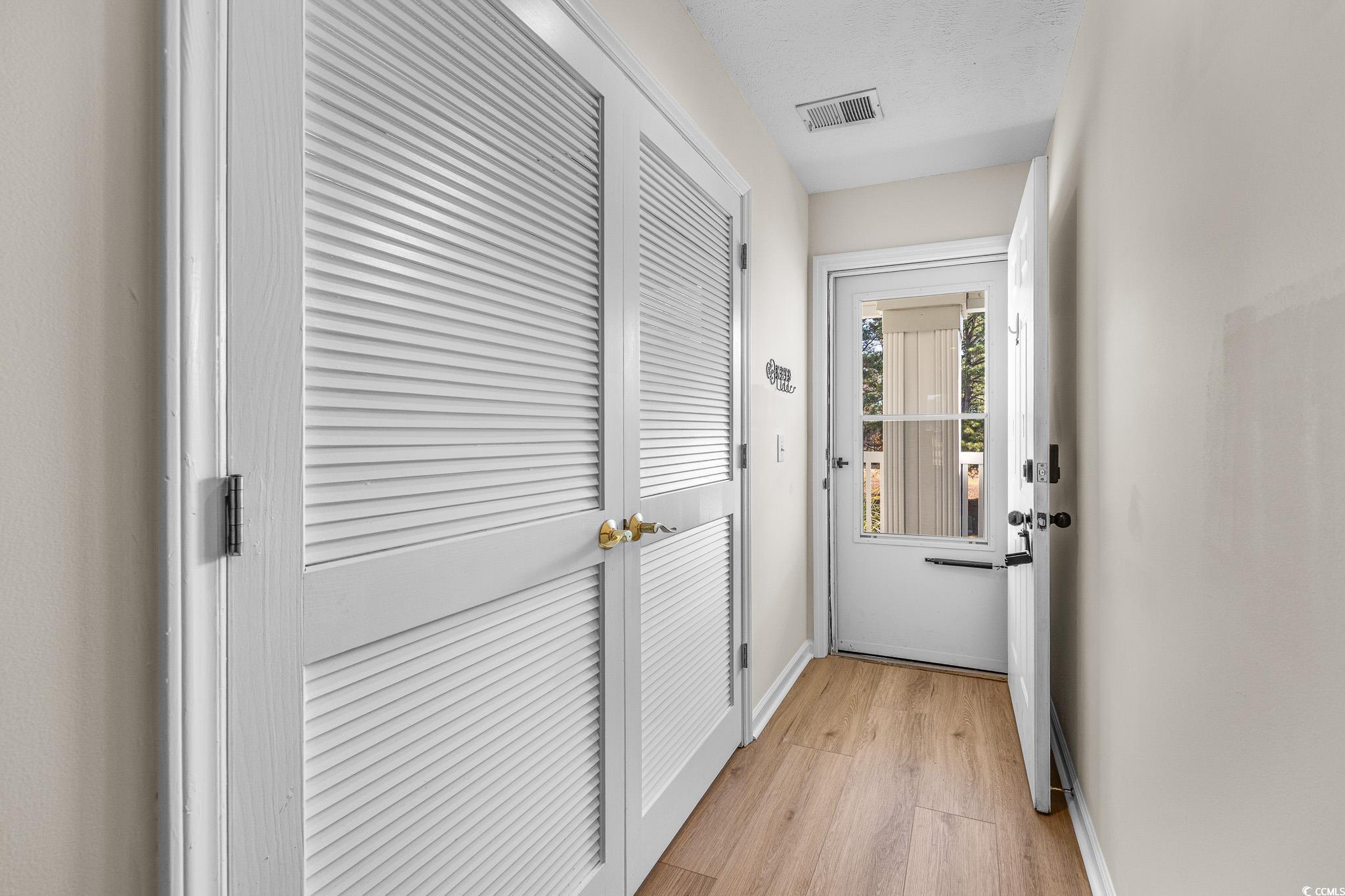 673 Tupelo Lane, Unit 19H Longs, SC 29568 - Photo 18 of 22 Doorway with baseboards and wood finished floors