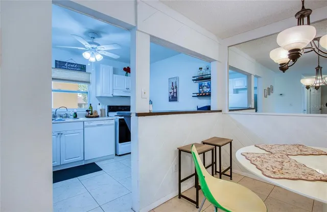 a kitchen with a table chairs stove and cabinets