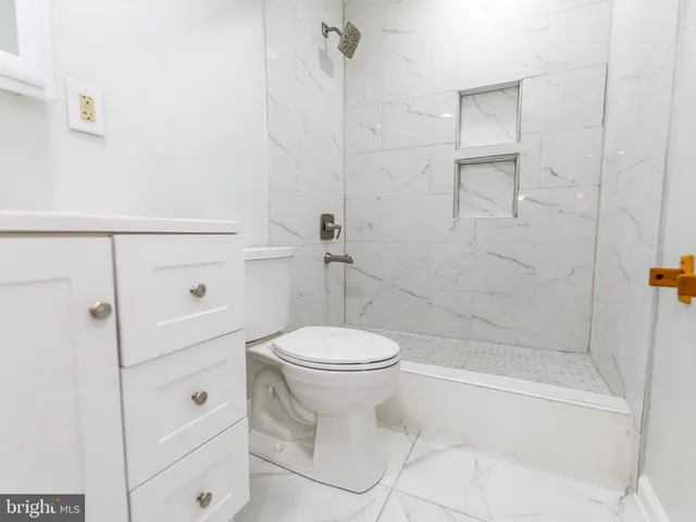 a bathroom with a toilet sink and shower