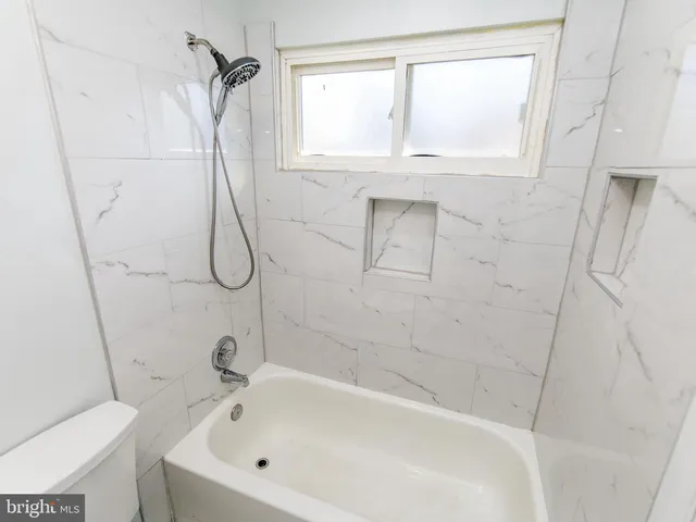 a bathroom with a bath tub and a shower