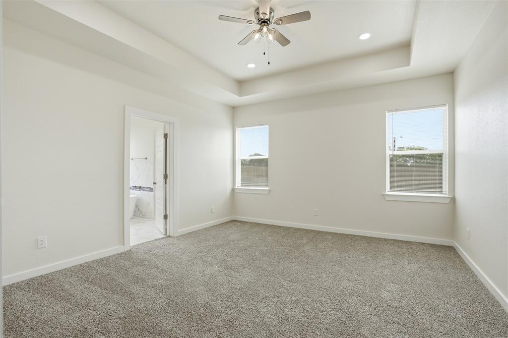 532 Highview Court Godley, TX 76044 - Photo 13 of 39 Spacious room featuring tray ceilings with recessed lighting and a ceiling fan