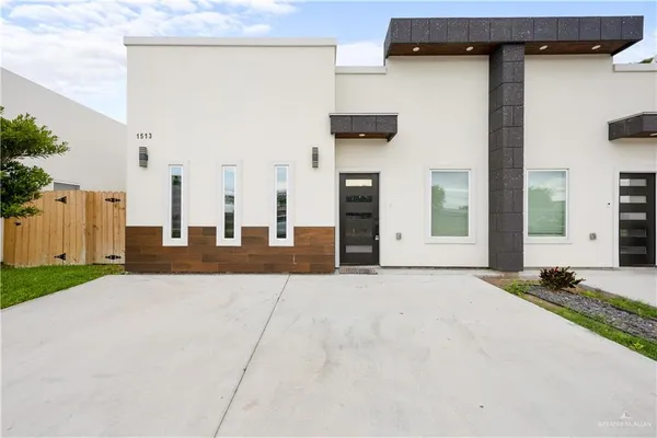 a view of a house with backyard and parking