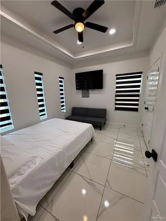 a bedroom with a large bed and a flat screen tv