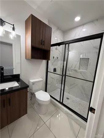a bathroom with a sink toilet and shower