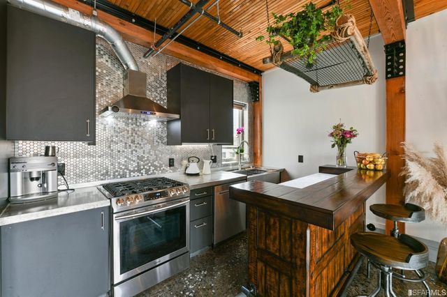 a kitchen with stainless steel appliances granite countertop a sink stove and cabinets
