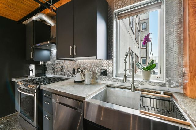 a kitchen with a sink stove and microwave