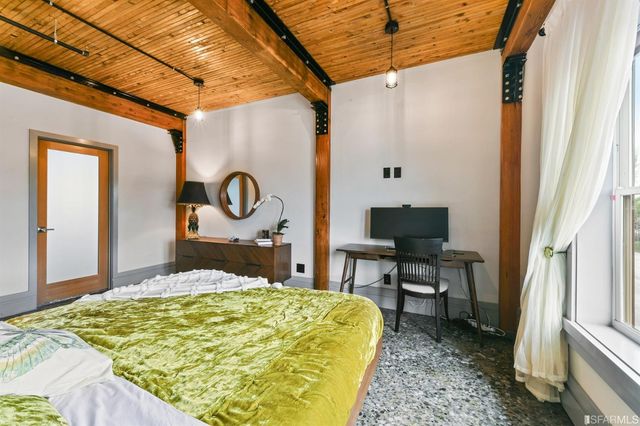 a bedroom with a bed and a table