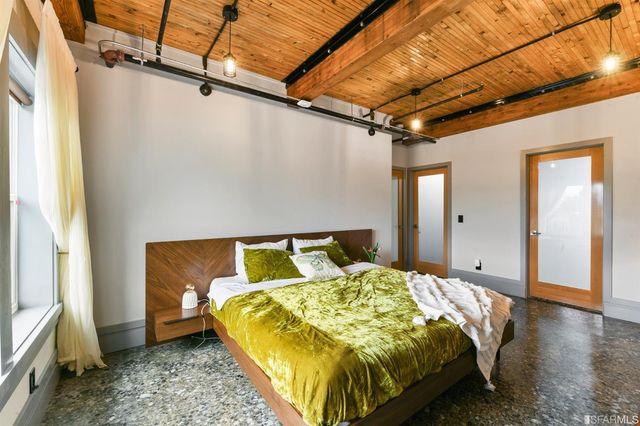 a bed sitting in a bathroom next to a window