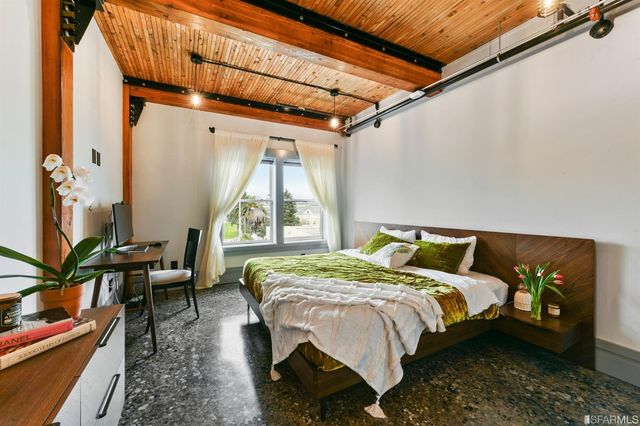 a bed sitting in a bedroom next to a window