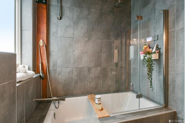 a bathroom with a tub and shower