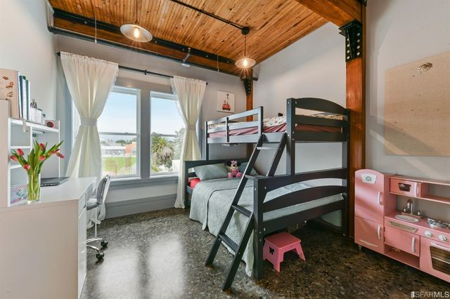 a bedroom with furniture and a window