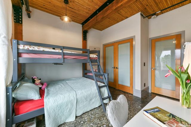 a bedroom with a bed and a mirror