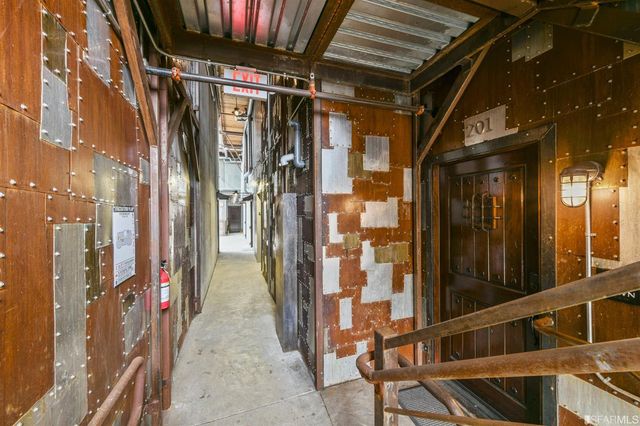 a view of a hallway with wooden door