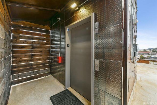 a view of a patio with a table and chairs