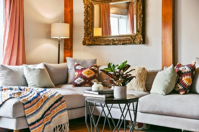 a living room with furniture flowerpot and a lamp