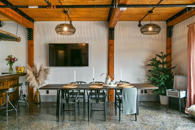a patio with table and chairs with potted plants