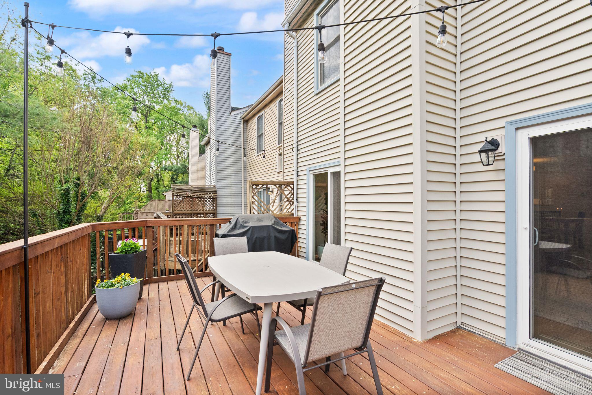 6369 English Ivy Way Springfield, VA 22152 - Photo 55 of 62 a view of a patio with table and chairs and wooden floor