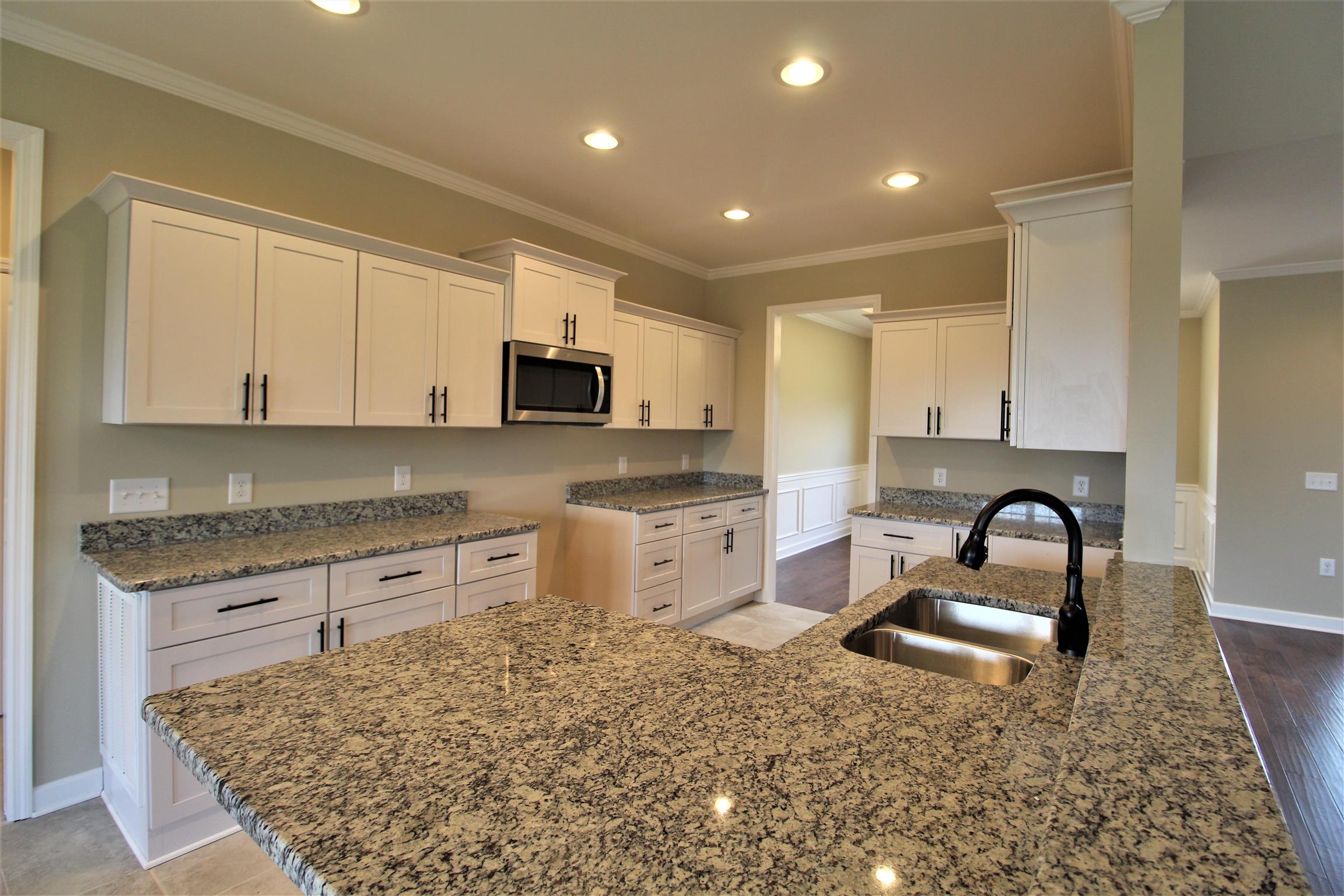2139 Turner Road Watertown, TN 37184 - Photo 7 of 30 a kitchen with stainless steel appliances granite countertop a sink stove and cabinets