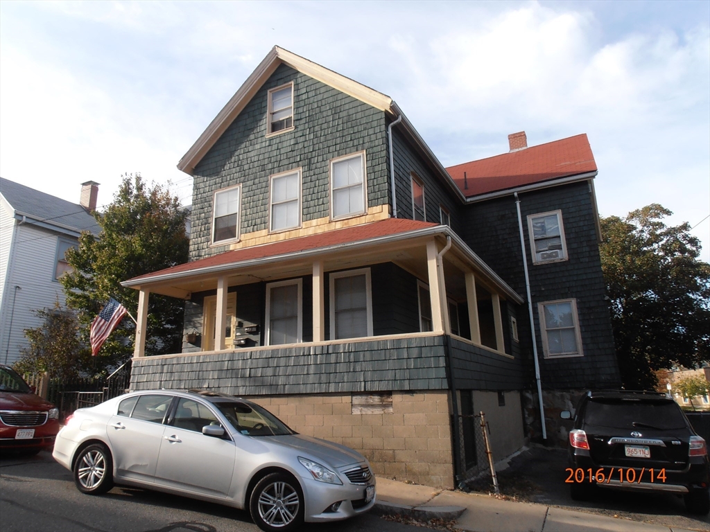 a front view of a house with parking space