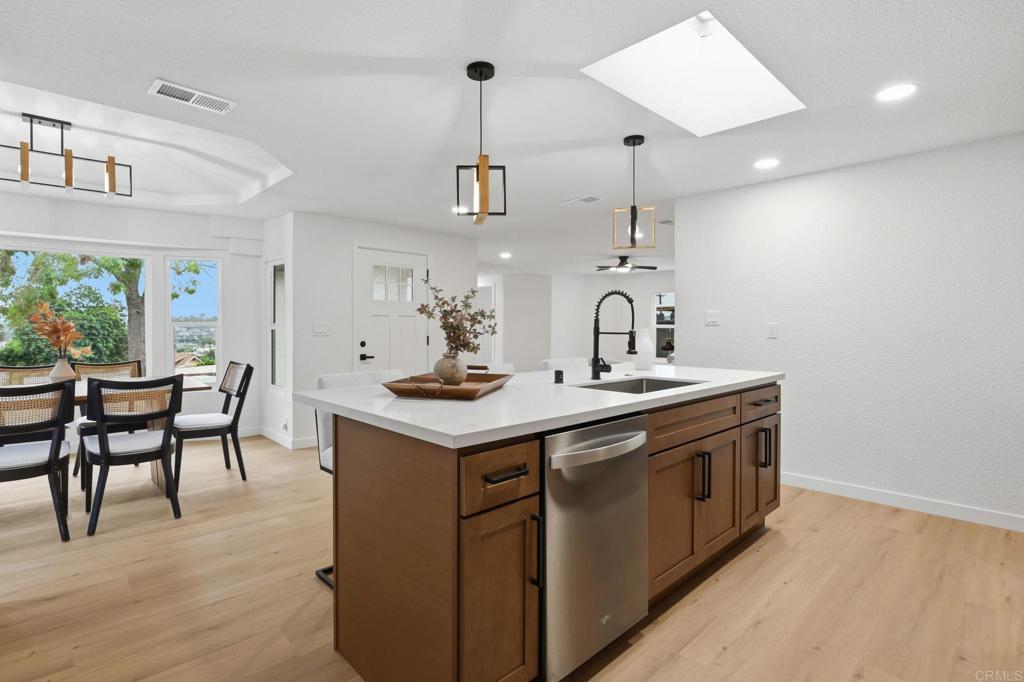 1333 Helix Street Spring Valley, CA 91977 - Photo 15 of 45 a kitchen with sink stove and wooden floor