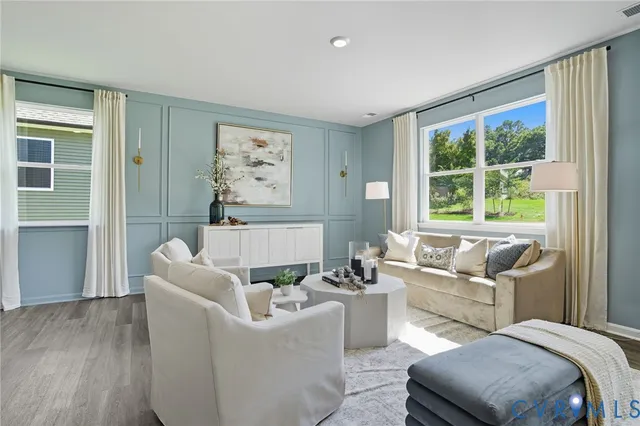 a living room with furniture and a large window