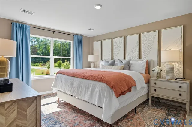 a bed sitting in a bedroom next to a window