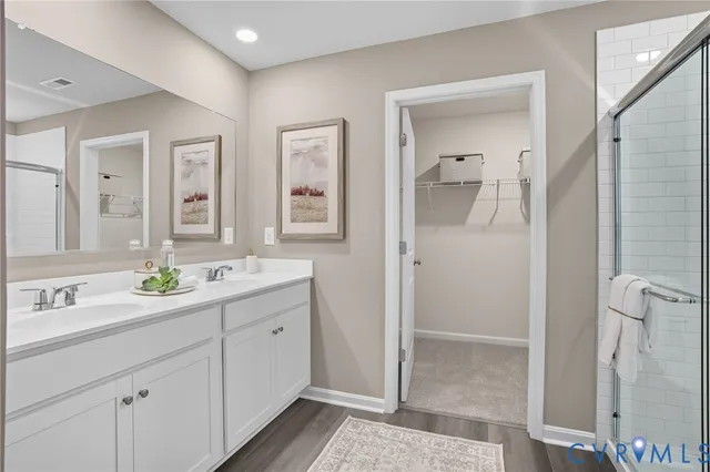 a bathroom with a double vanity sink mirror and shower
