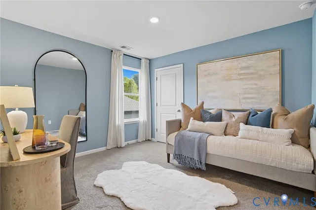 a living room with furniture a rug and a window